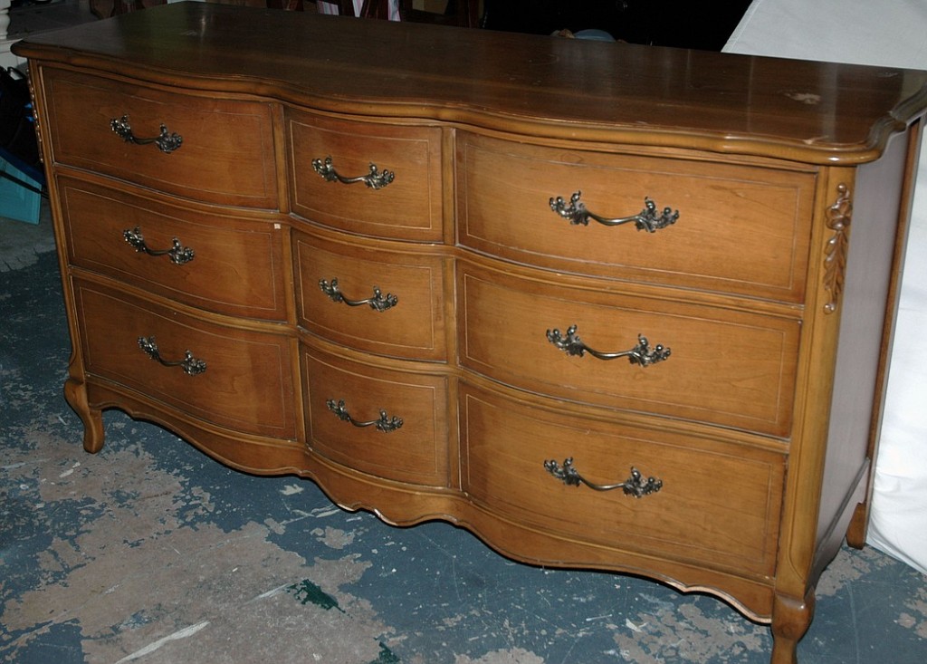 A "before" photo of an old dresser before it was painted using Annie Sloan Chalk Paint.