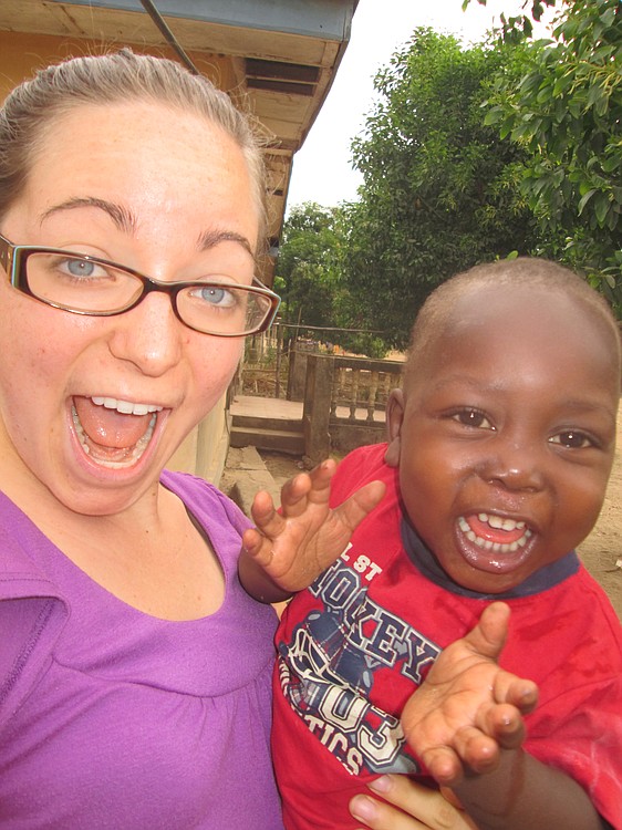 Paige Webberly goofs off for the camera with her favorite neighborhood child, Hassan.