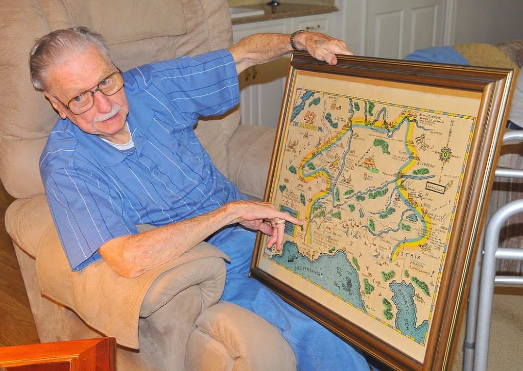 Camas resident George Willis, a World War II veteran, points out the places where the 42nd Infantry Division, known as the "Rainbow Division" battled to defeat Nazi Germany. The map was created shortly after the war.