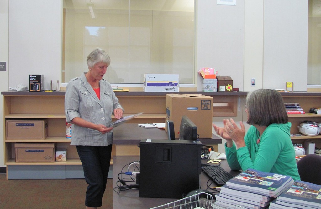 Principal Jan Strohaier chats with librarian Marge Crouch as she organizes books and other materials. Crouch, who was a classroom teacher for many years, spent hours researching and ordering new items for the library. "I work with the teachers and get to know what they like, and get books that fit the curriculum," she said.