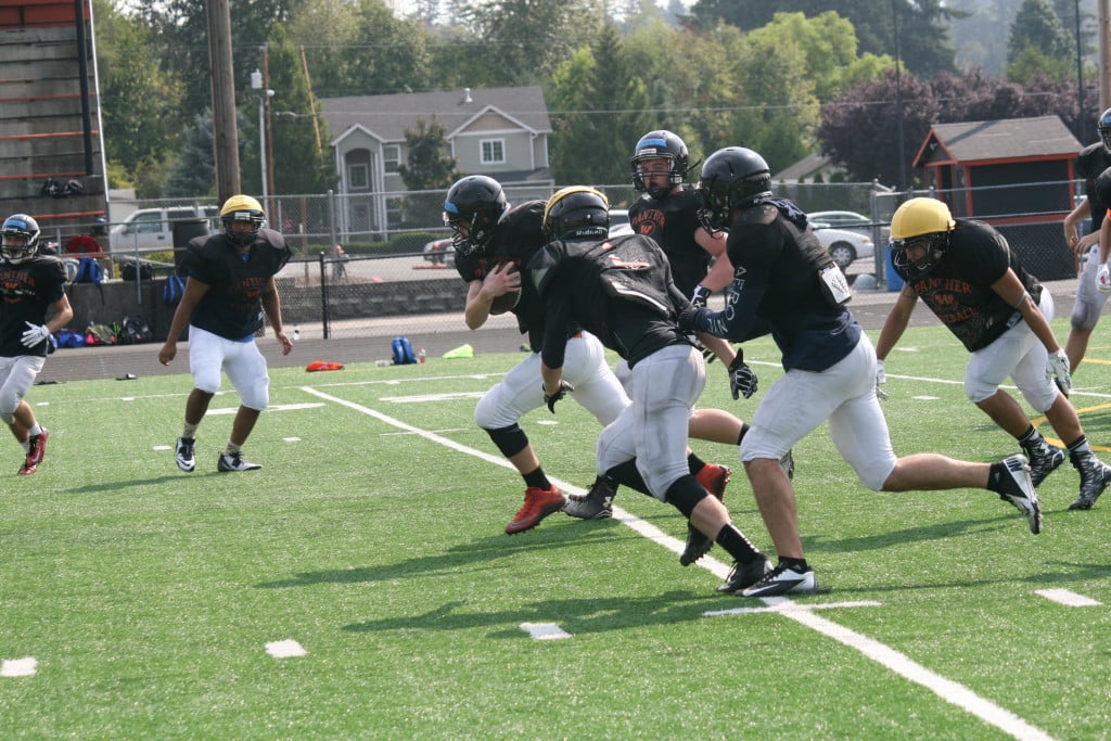 Zack Neketuk runs up the gut for the Washougal High School football team during the first week of practice at Fishback Stadium.