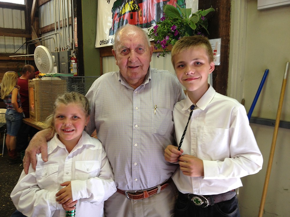 Dakota and Hannah pose with judge Vern Palmblad after a 4-H event at the Skamania County Fair. Watson swept several rabbit categories.