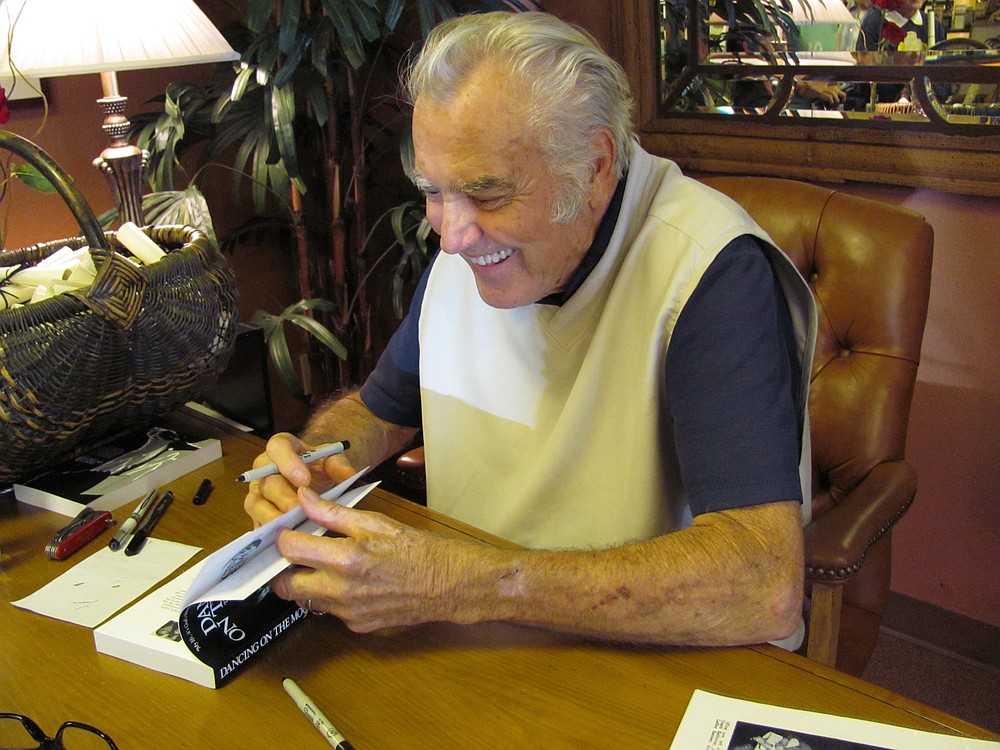 Jimmie Rodgers signs copies of his book, "Dancing with the Moon," in downtown Camas in 2012.