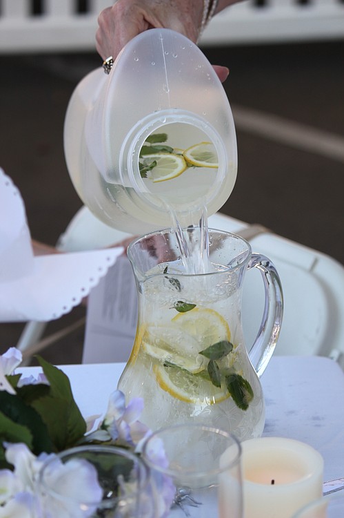 At the Camas-Washougal Soroptimists' table, refreshments with hints of lemon and herbs were poured into delicate glass pitchers. The group's other table decorations included white flowers, teddy bears and candles.