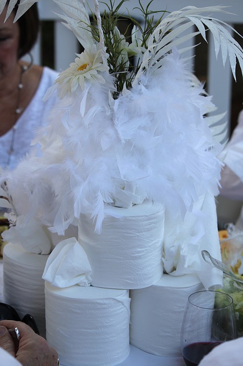 Participants got creative with their table decorations, including paying homage to the city's paper mill history with centerpieces made of rolls of toilet paper, accented with feathers and flowers.