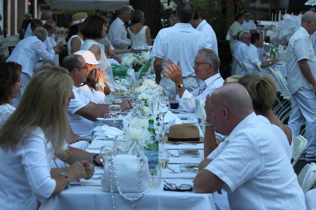 Friends and family enjoy food and drinks at the Camas in White event. Tables and chairs were set up on Northeast Fourth Avenue, between Adams and Birch streets.