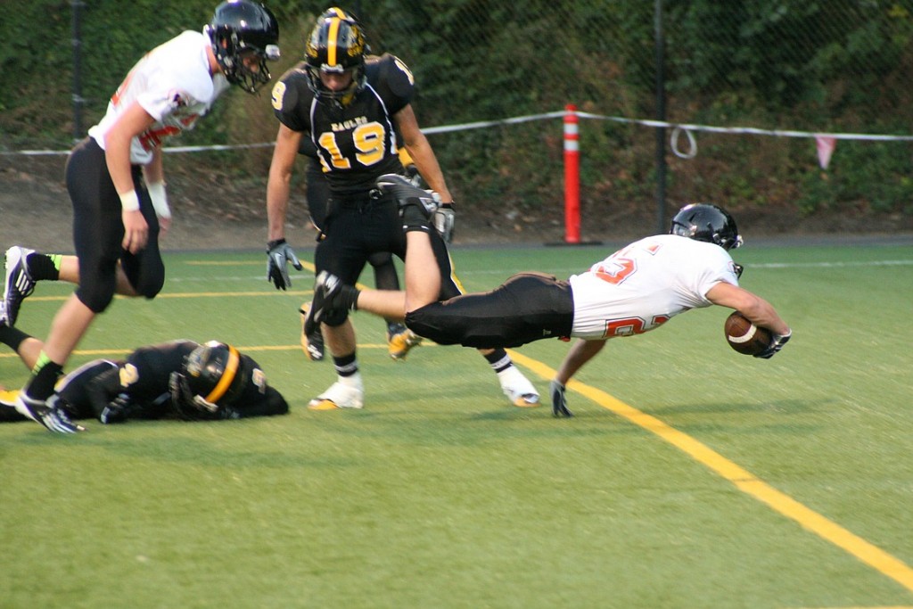 Stephen Camden dives into the end zone to score the first of four touchdowns. He had 11 carries for 116 yards.