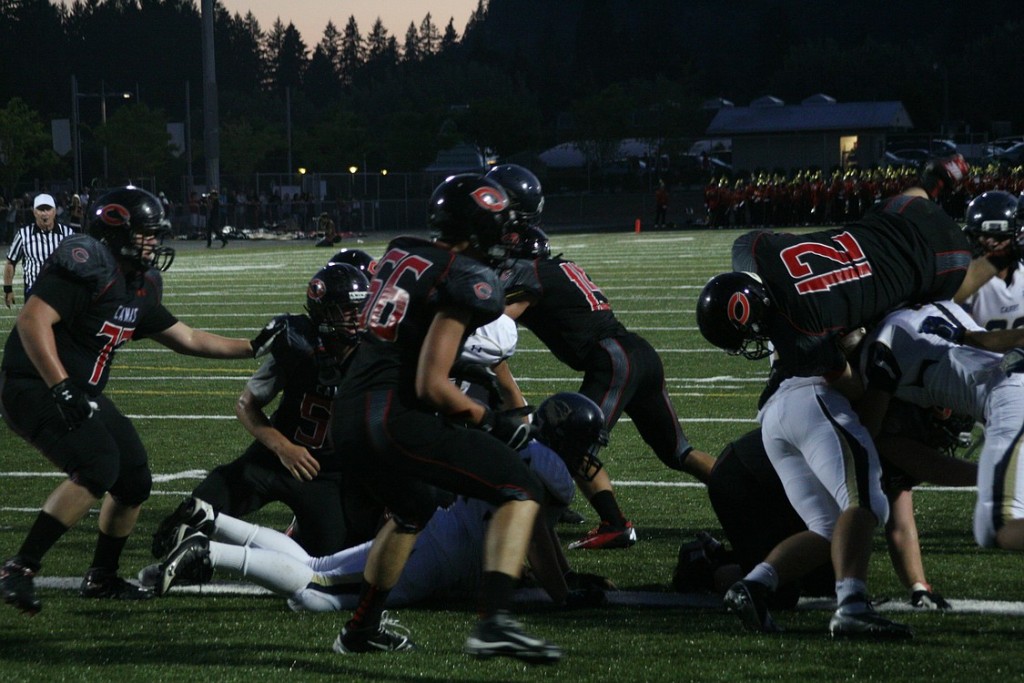 John Norcross jumps over the line of defenders to score the first of his two touchdowns Friday night.