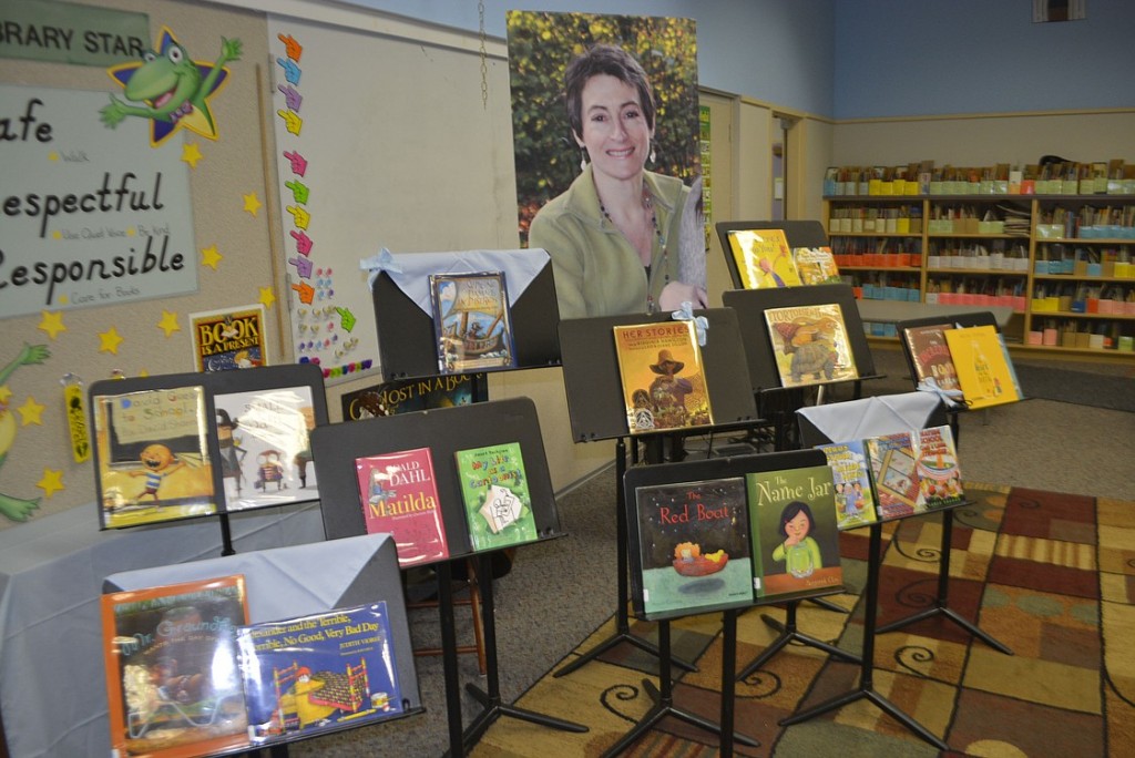 Andrenae Merideth, Michele and Anthony Loveall and Tyler Merideth peruse one of the many new books at the Hathaway Elementary School library. More than $7,000 was donated in memory of third-grade teacher Susan Champion.