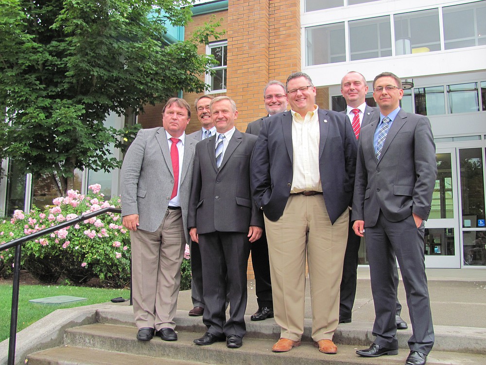 Camas Mayor Scott Higgins (center) poses on the steps of the Camas Public Library with mayors and council members from cities in Poland, the Czech Republic and Germany.  The delegates arrived on Sept. 13 and are set to depart today. While in Camas, they toured local businesses and City Hall, dined at local restaurants, toured Microsoft, went sightseeing via train, and were the honored guests at the Portland Polish Festival.