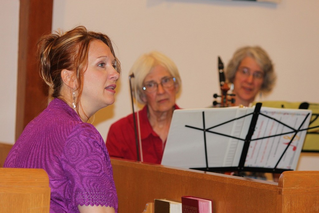 Community orchestra members Elisa Wells (right) and Kathy Stuart (center) listen as Conductor Tatiana Kolchanova (left) provides instruction to the group. Kolchanova, who moved to the United States from Russia in 2007, has spent most of her life performing, teaching, composing and conducting. "I wanted to share my experience with others," she said.
