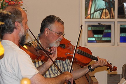 Seth Moran (left) and Larry Hoffman play violas during a recent community orchestra practice session. The group, which currently has about 14 members, meets every Thursday, from 5 to 7 p.m., at Camas United Methodist Church.