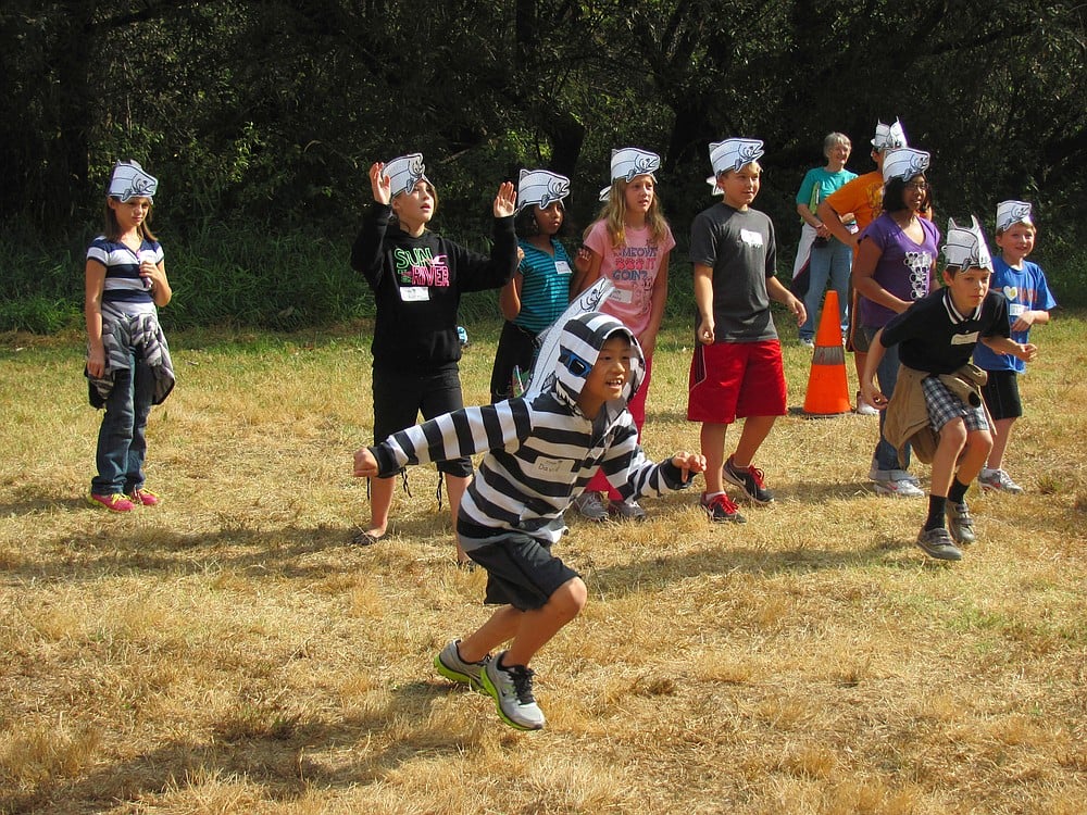 Fourth-grade students run through a salmon obstacle course on Friday as a part of the Columbia River Watershed Festival at Capt. William Clark Park.