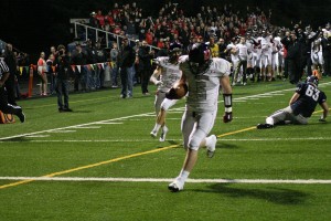 The Camas football players, coaches and fans go crazy as Brad Hansen returns a fumble for a touchdown Friday, at Kiggins Bowl.
