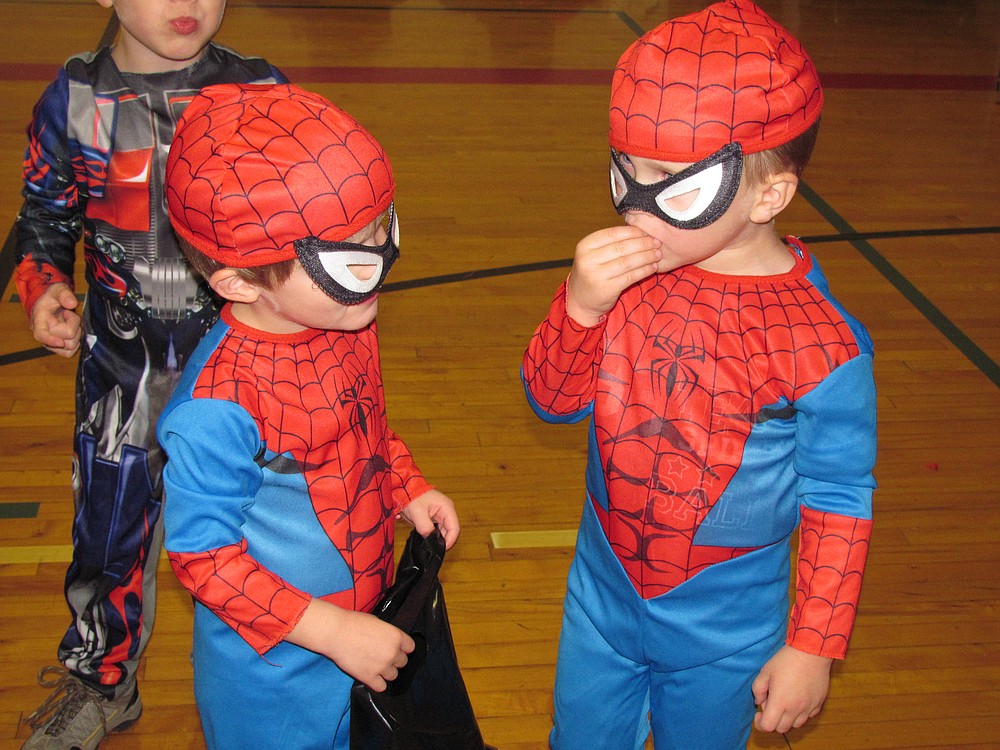Family Halloween Night in Camas features a costume contest, carnival games and lots of candy. Here, two spidermans compare costumes.