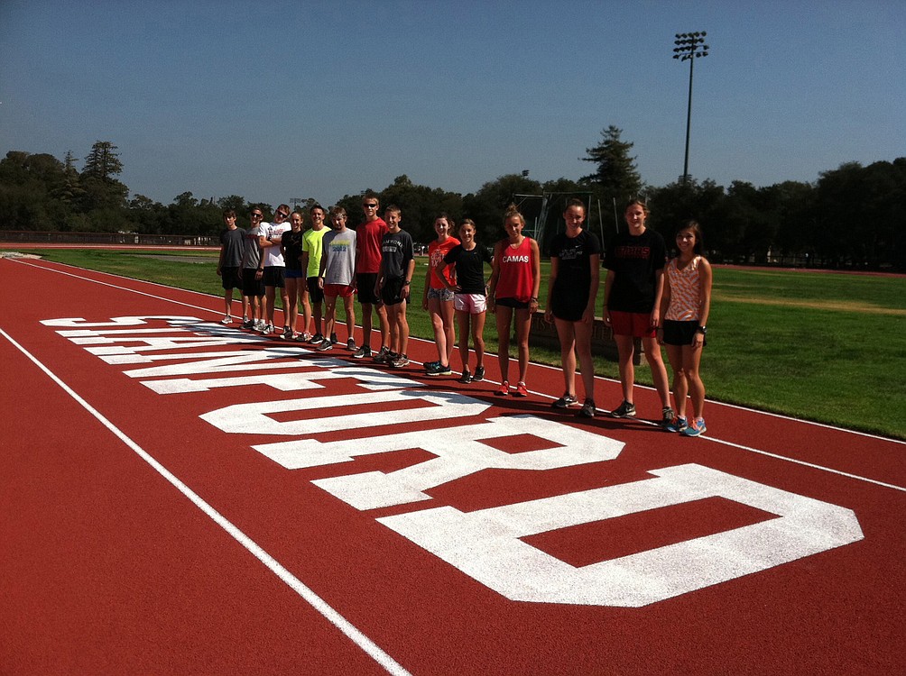 The Camas High School cross country runners stand on the track at Stanford University.