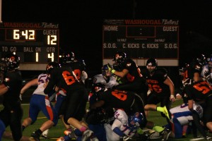 Offensive linemen for Washougal push Ridgefield off the goal line while Bobby Jacobs jumps over the pile to score one of his four touchdowns Friday, at Fishback Stadium. The Panthers defeated the Spudders 36-18.