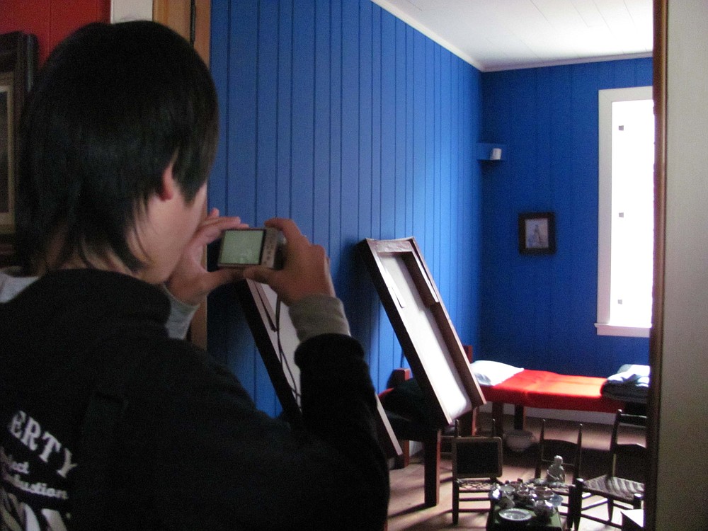 A Taki student photographs a playroom in Chief Factor's house.