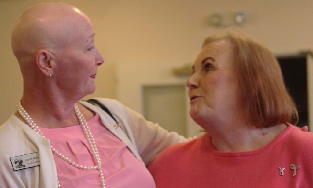 Jennifer McDaniel, who is battling breast cancer, exchanges a hug with friend and seven-year breast cancer survivor Janet James at the Columbia Ridge Senior Living Pink Tea Party last week. October is National Breast Cancer Awareness Month.