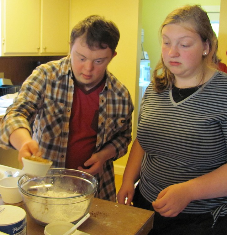 Tim Younger and Mary McFarland combine ingredients for zucchini bread. The Transition House helps students learn cooking and baking, among other skills necessary for independent living.