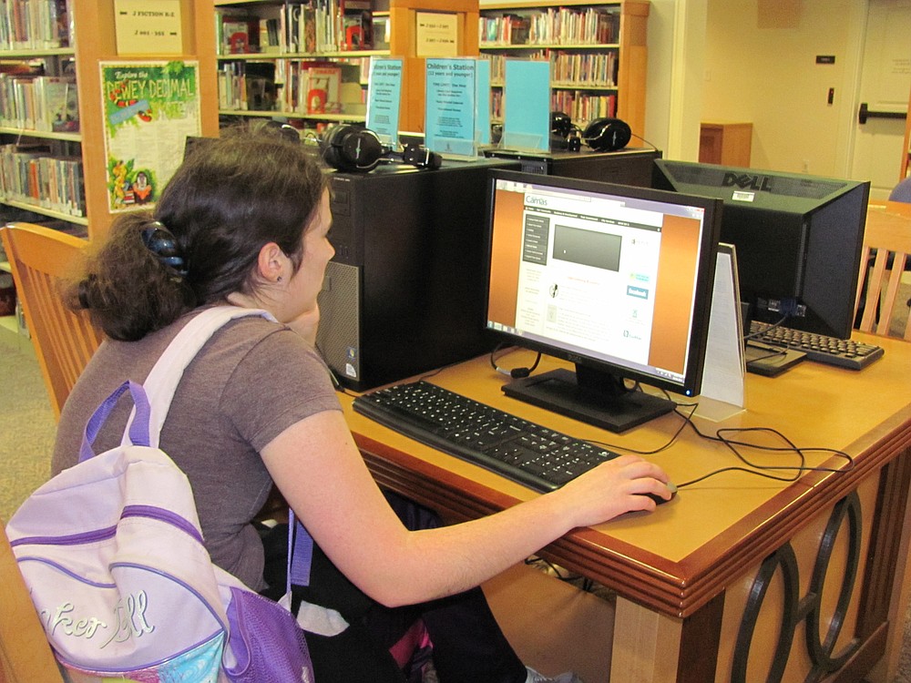 Kiersten Leathers, 19, researches recipes for zucchini bread on Pinterest at the Camas Public Library. She is in her first year of the Camas School District's Transition House, which teaches students with special needs daily living skills.