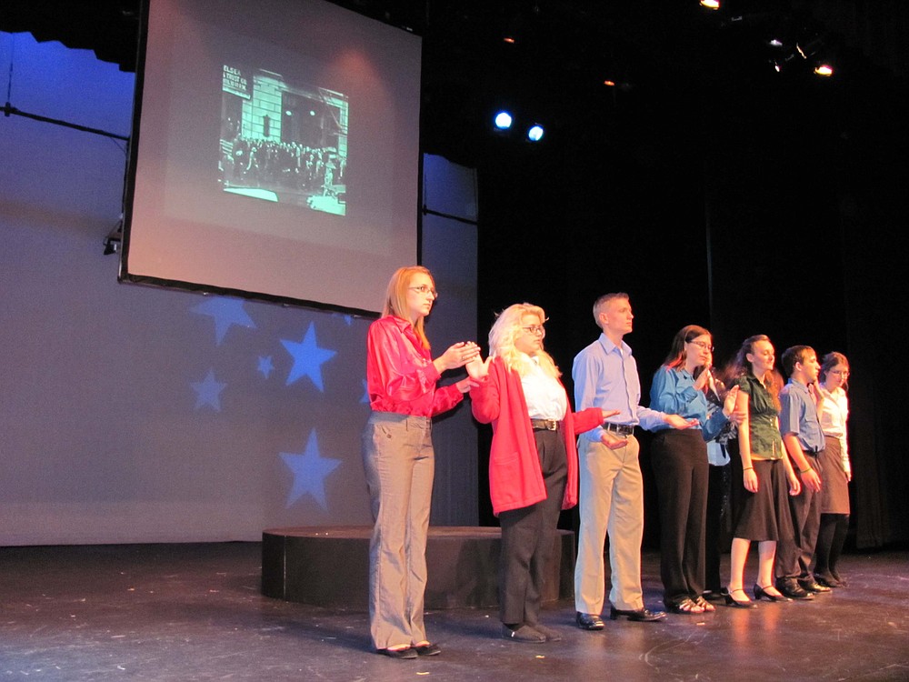 The cast of the Hoover play forms a machine of state, prone to frequent break-downs.  Left to right, are Mikayala Harris, Angelica Bartorelli, Carson Connors, Miranda Sutton, Taylor Wilcox, James Stout and Shannon Leininger.