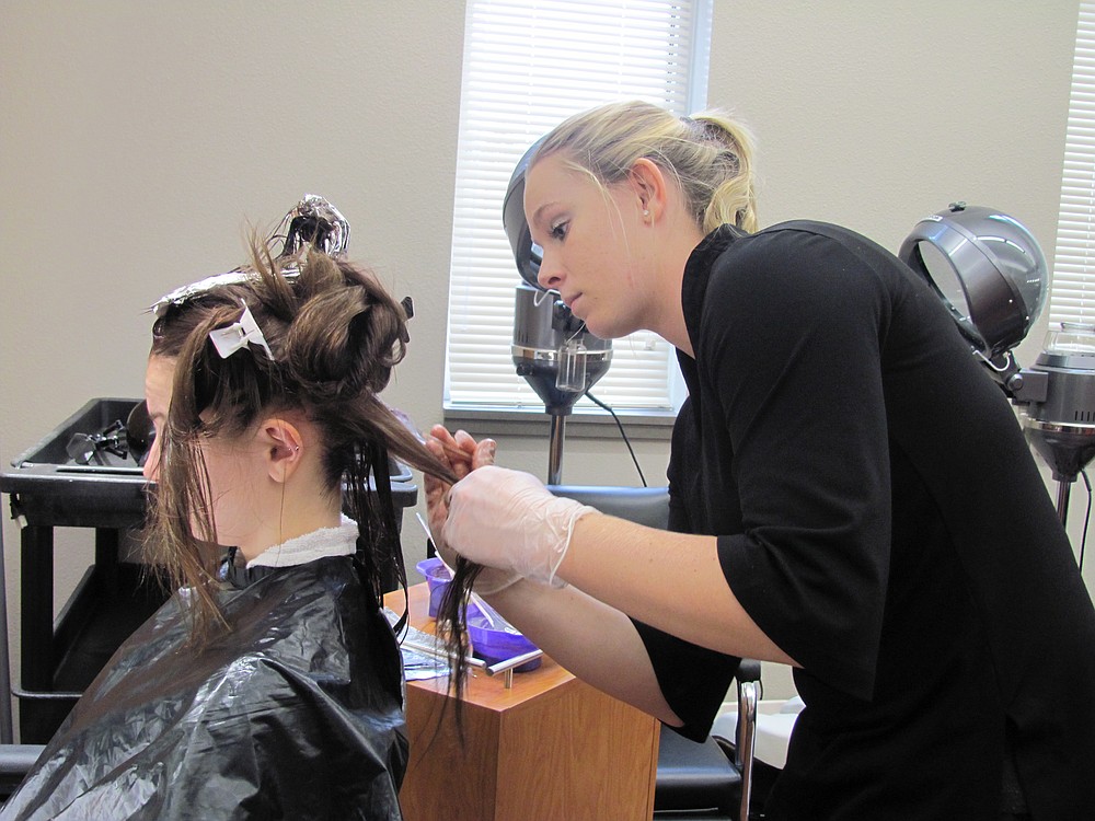 Makayla Hendrix of Camas applies color to a classmate's hair in a salon located inside the Clark County Skills Center costmetology program's new building. "I love to do color and see the end results and looks on people's faces," she said.