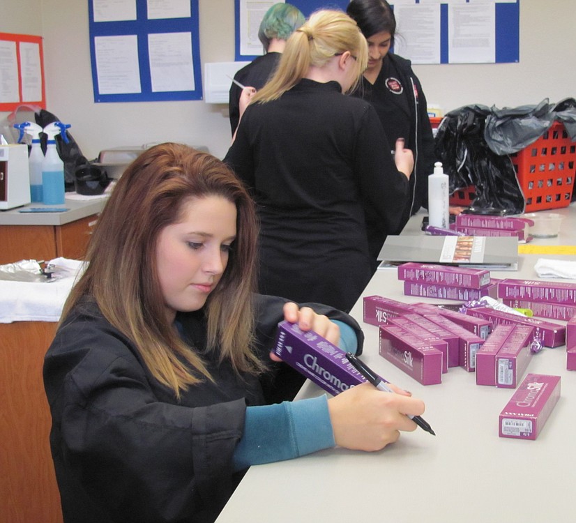 Desi Scheu attends Camas High School in the morning and is a second-year student at the cosmetology program in the afternoon. Here, she conducts inventory on hair color products. Scheu attends classes for eight hours a day between her two schools.