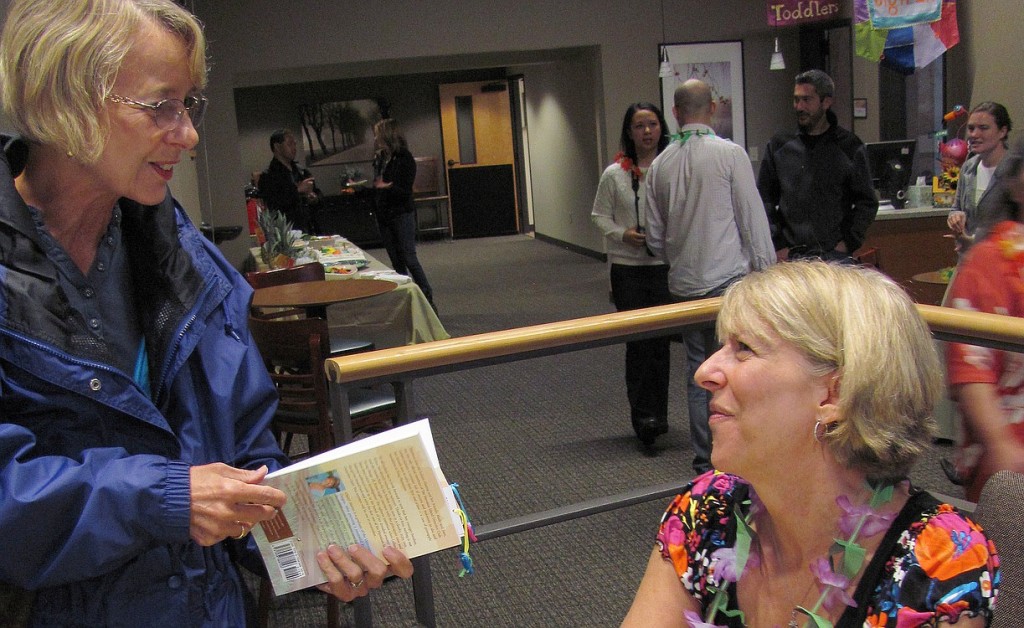Author Cheryl Linn Martin visits with a fan at the book release party at Journey Community Church.