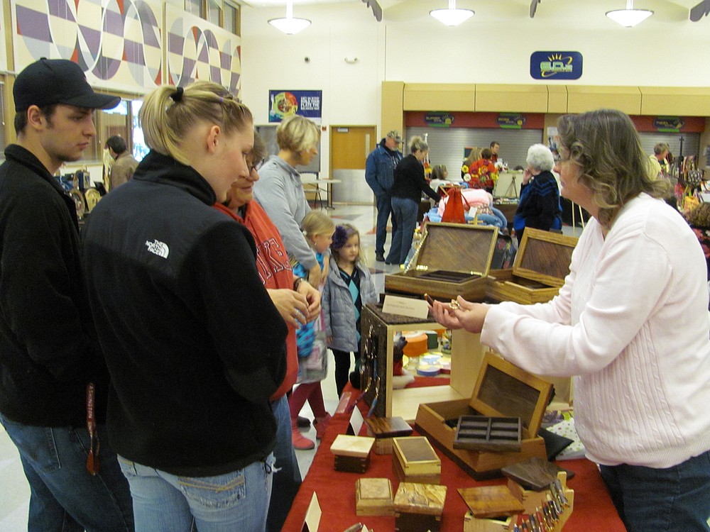 Attendees puruse jewelry and music boxes at the Holly Days Craft Bazaar in Camas.