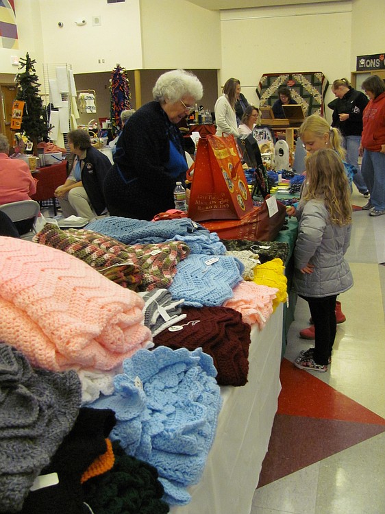 Colorful handmade blankets line the tables at the Holly Days Craft Bazaar in Camas.