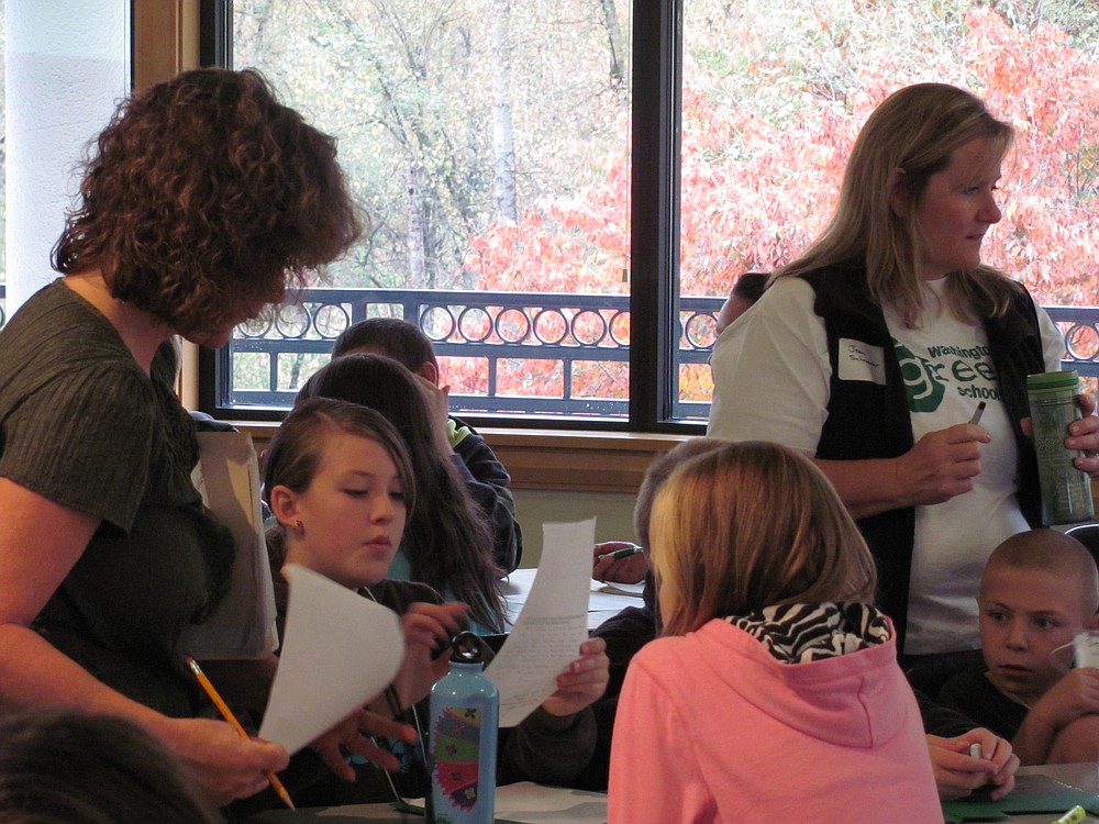 Grass Valley Elementary teachers Julie Della-Valle (left) and JeanSchroeder work with students on a "share your story," activity.