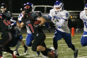 Nate Beasley cuts by three defenders and inches toward his fifth touchdown of the game Saturday, at Doc Harris Stadium. Camas hammered Federal Way 65-32 to earn the opportunity to play in the Tacoma Dome again this weekend.