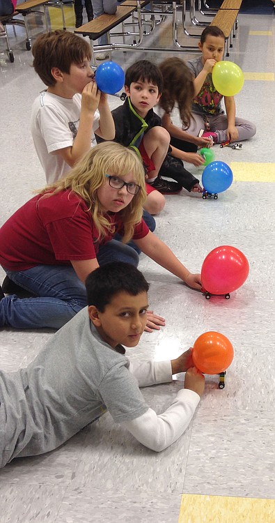 Students at Gause Elementary School race their balloon-powered cars during Lego Club.