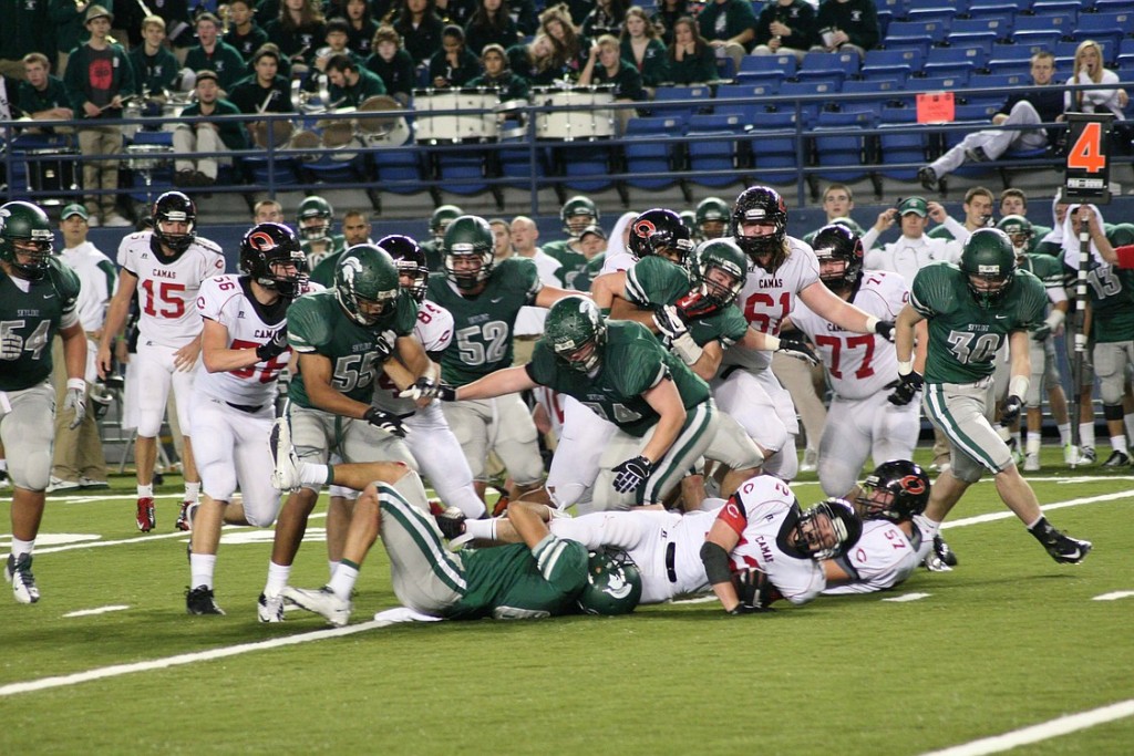 John Norcross gains a first down for the Papermakers with help from offensvie linemen Matt Danis, Robert Ward, Jason Vailea, Drew Clarkson, Chris Durrett and Troy Patterson.