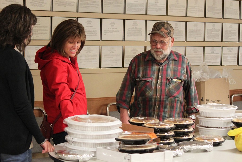 Volunteers Lora Rollins (center) and her daughter, Isabella, 12, talk to Al Schmid, who leads the annual coordination of the Knights of Columbus Thanksgiving dinner preparation and delivery. Schmid, 75, has been participating in the effort for 29 years. "He is very humble," Lora Rollins said of Schmid. "He does so much. He is always there to lend a hand if you need it. I just can't say enough about him." Look for additional photos from the event at www.camaspostrecord.com.