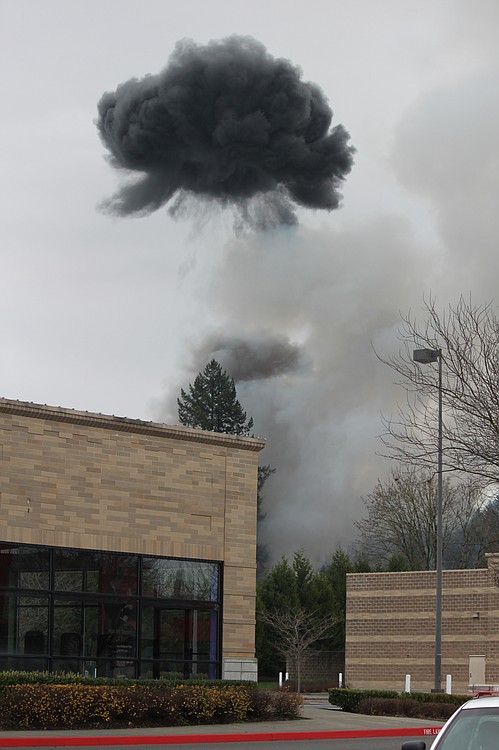 Smoke billows from the scene of a house fire and shooting at 3275 "F" Place in Washougal. Emergency crews responded to the scene just after 8 a.m. Wednesday morning. Homes and businesses within a four-block perimiter were evacuated.