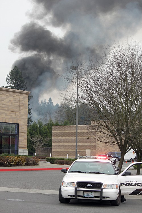 Smoke billowed from the scene of a house fire and shooting at 3275 F Place in Washougal. Emergency crews responded to the scene just after 8 a.m. Wednesday.