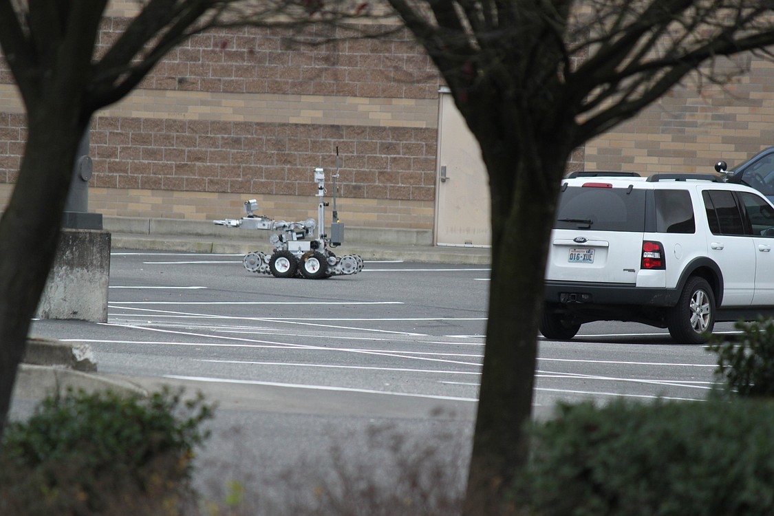 Robots equipped with video cameras were used by police to safely survey the scene.
