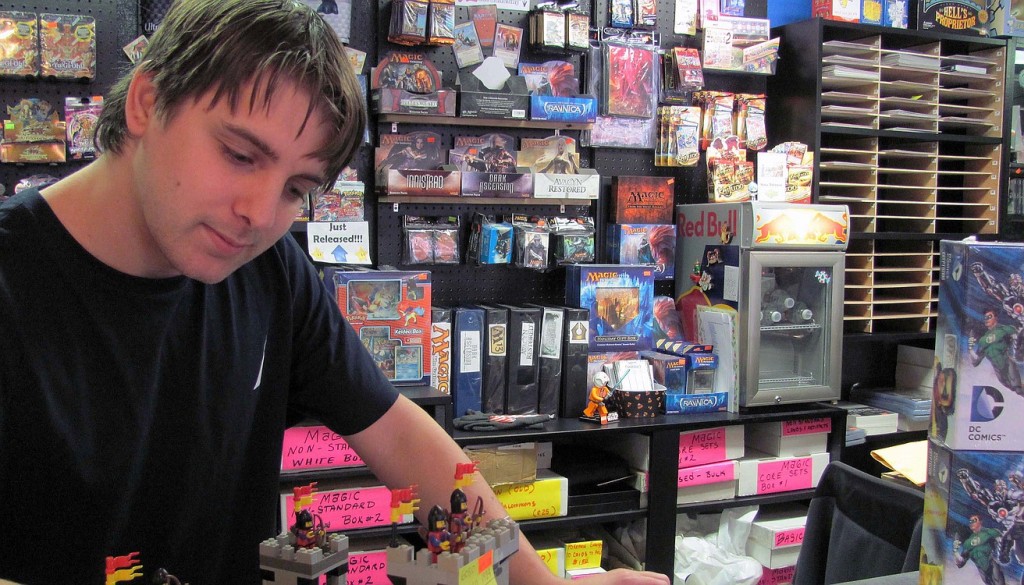 Jake Peterson, a consultant at Hero Support, works on a Lego set. Legos, new and used, are one of the many stocking stuffers available for under $15 at the store.