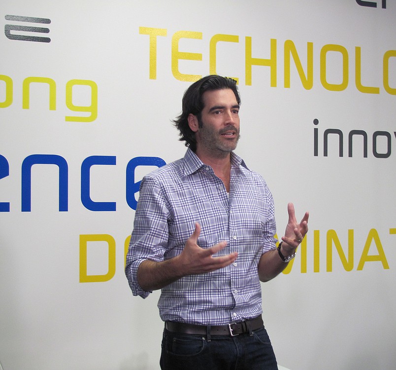 Carter Oosterhouse addresses the crowd during the opening of the tween tech center at the Jack, Will and Rob Boys & Girls Club. Oosterhouse, known for his work on TLC's "Trading Spaces," collaborated with the kids to design the center.