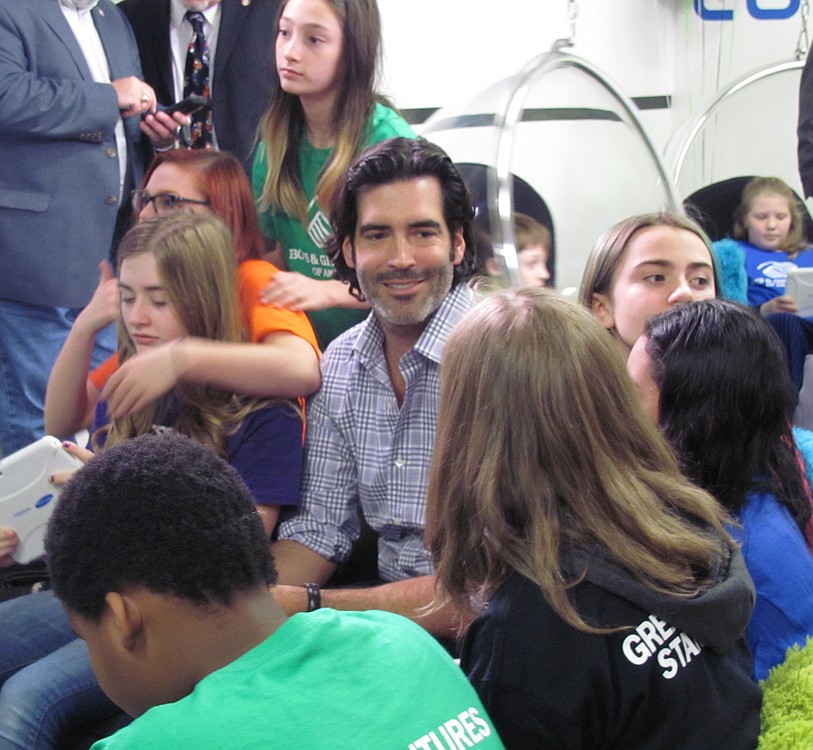 Carter Oosterhouse chats with middle schoolers during the new tween tech center's "big reveal" party at the Jack, Will and Rob Boys & Girls Club.