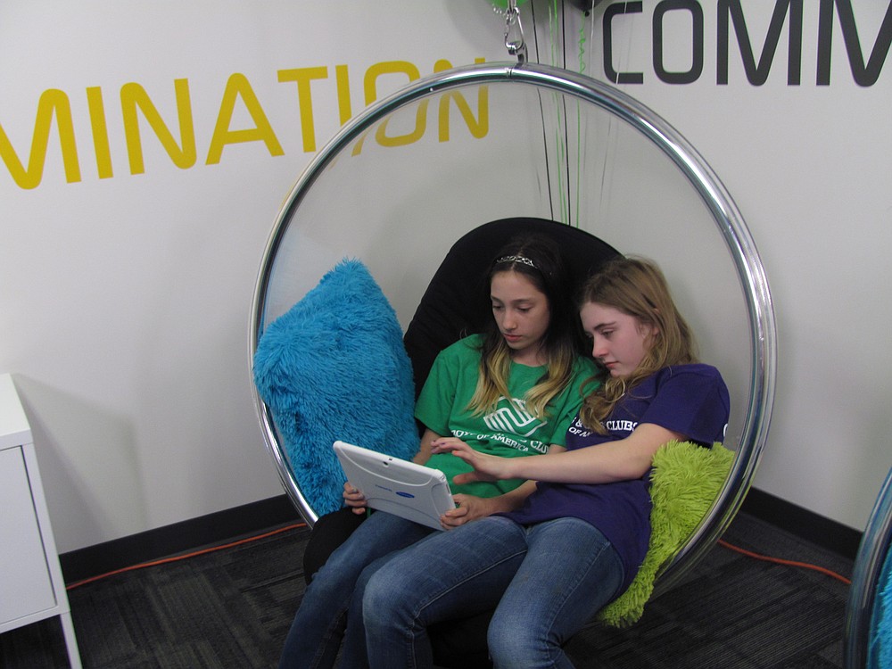 Bailey Green (left) and Sierra Hobson explore one of the Samsung tablets during the "big reveal."
