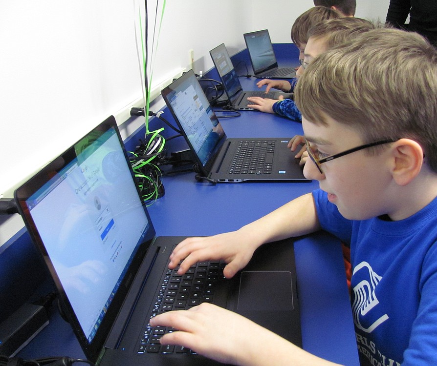 Sam Schober, 12, checks out the laptops. "It looks so good now in here," he said. The space was previously used as a storage area.