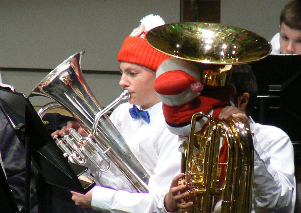 Members of the Metropolitan Youth Symphony get festive while performing at a recent winter concert. John Neumann, left, has been playing with the band for four years.