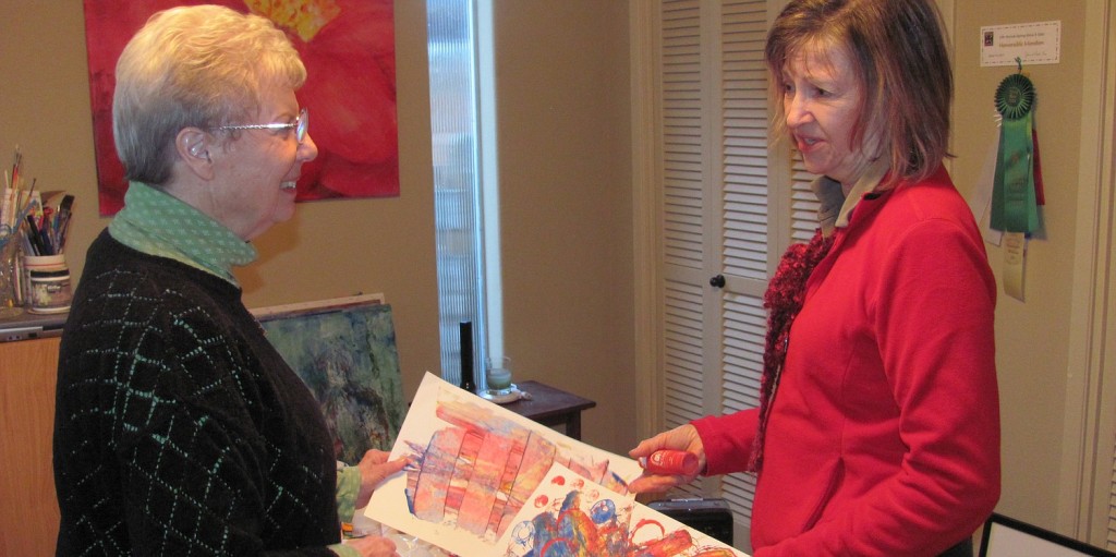 Fellow artists and friends Katey Sandy (left) and Judith Howard reminisce about a children's art project they collaborated on prior to retirement. The two will host an art show, which opens Friday at the Second Story Gallery.