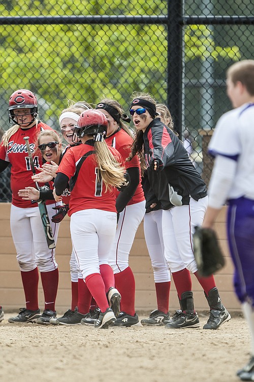 Camas softball players celebrate a home run by Lena Richards.