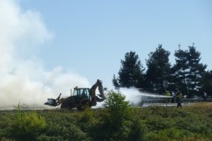 Firefighters work to extinguish a blaze after a truck carrying hay caught on fire Tuesday afternoon at Highway 14 in Washougal.