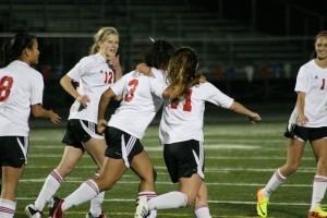 The Camas girls soccer team celebrates the first of four goals scored against Wenatchee Wednesday, at Doc Harris Stadium.