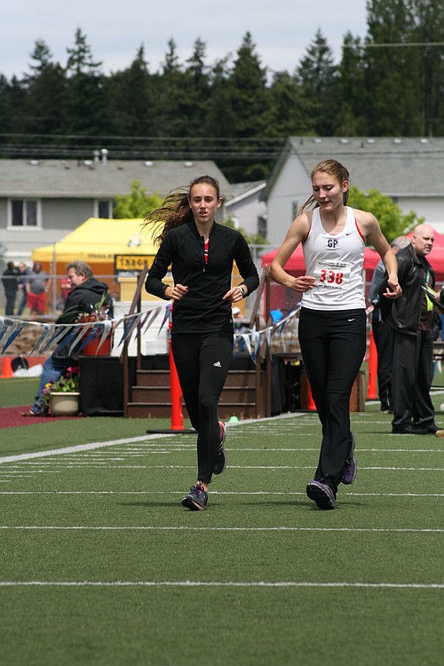 State rivals Alexa Efraimson, Camas, and Amy-Eloise Neale, Glacier Peak, cool down together. Racing fans remember their epic battle for the 800 state championship a year ago.